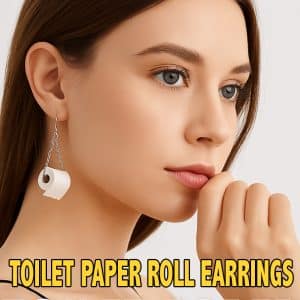 A stylish close-up portrait of a woman wearing quirky toilet paper roll earrings, designed to look like miniature rolls of toilet paper on silver hooks.