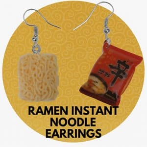 Ramen instant noodle earrings with mismatched design — one shaped like a noodle block, the other like a red ramen package.